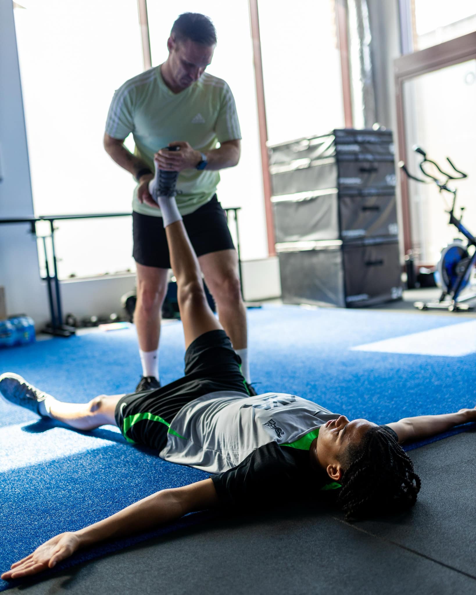 Mike Edge performing specialized mobility work with a professional athlete during a training session