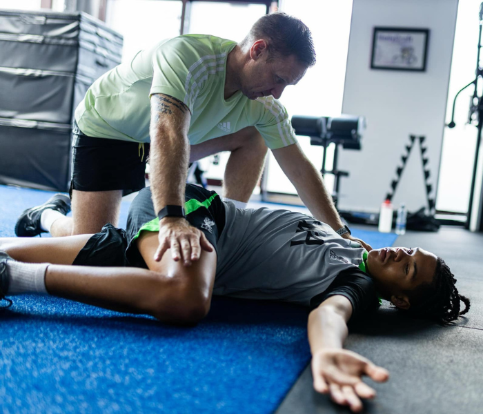Professionalism & Lifestyle - Coach providing recovery and injury prevention treatment