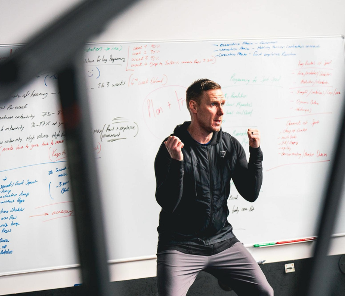Tactical Intelligence - Coach demonstrating positioning in front of tactical whiteboard
